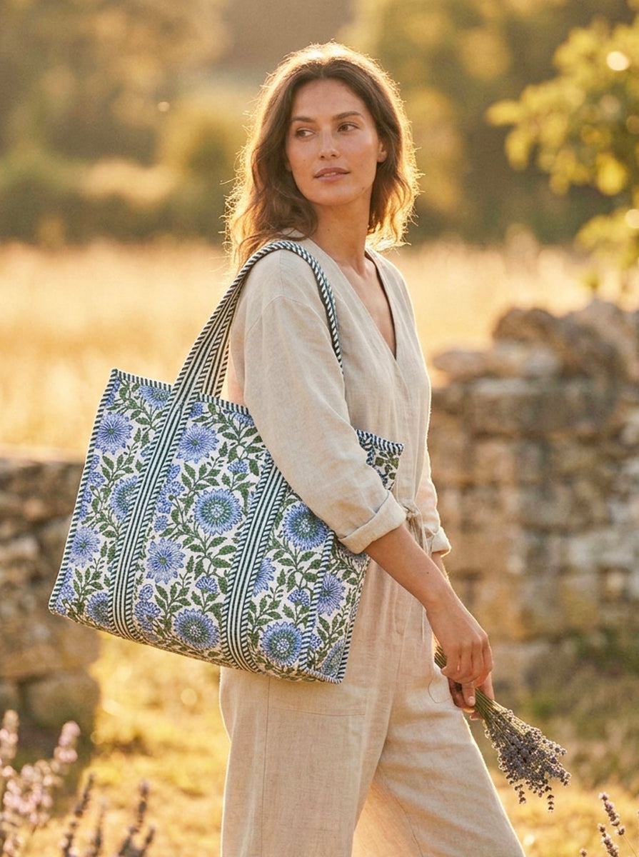 Women wearing a large floral tote bag in an outdoor setting at sunset