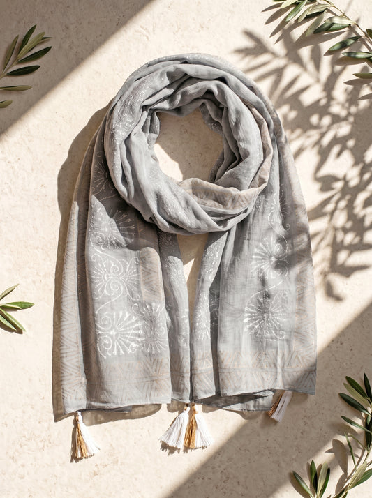 Gray scarf with tassels on a beige background
