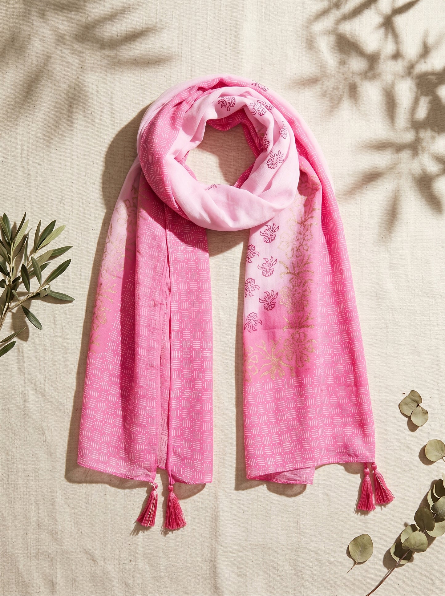 Pink block printed scarf on a beige background