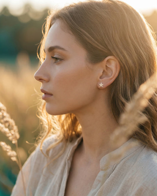 Woman wearing star-shaped earrings in a natural setting